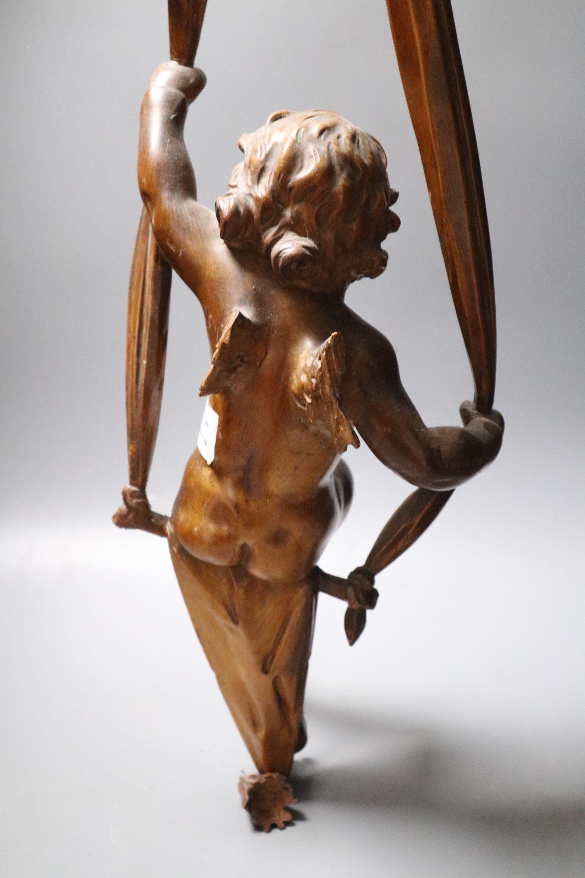 A late 19th century hanging wooden cherub